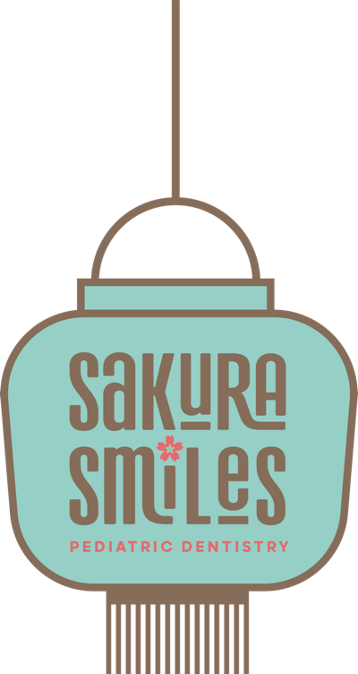 A paper lantern with the Sakura Smiles logo, hanging from a branch