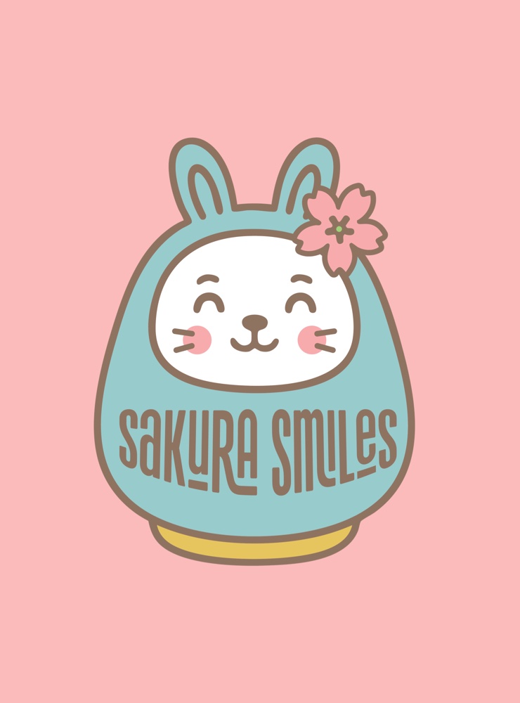 The Sakura Smiles daruma doll badge